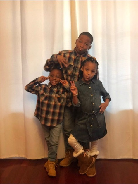 Karmelo Anthony as a child with younger siblings in matching plaid shirts