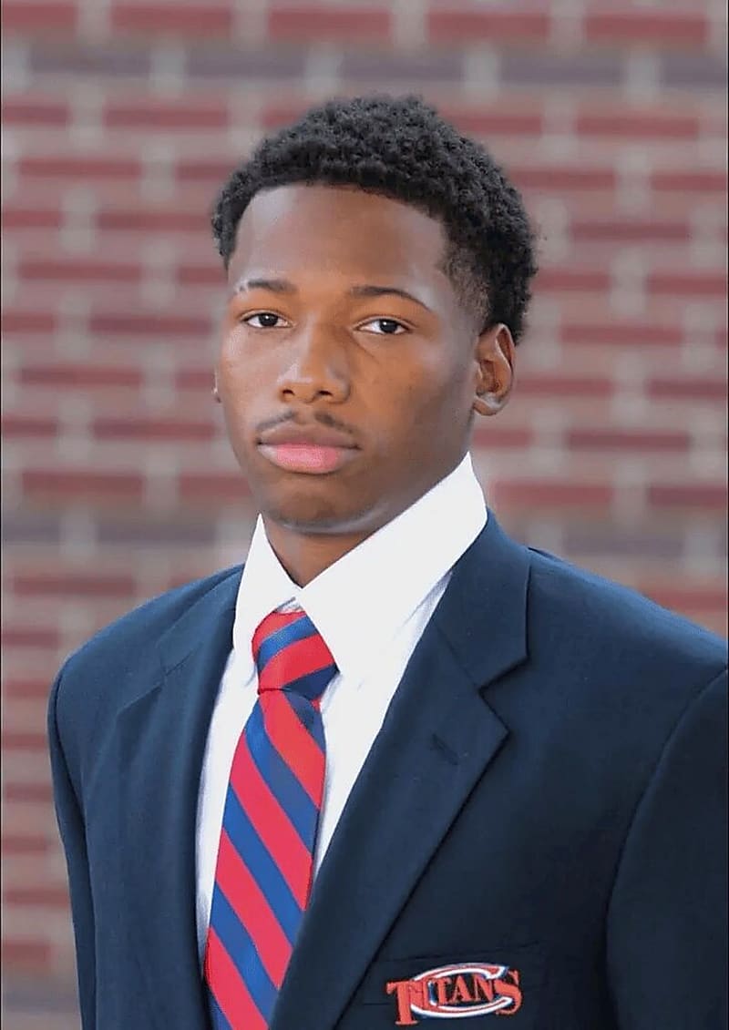 Karmelo Anthony in a navy blazer and striped tie, school portrait
