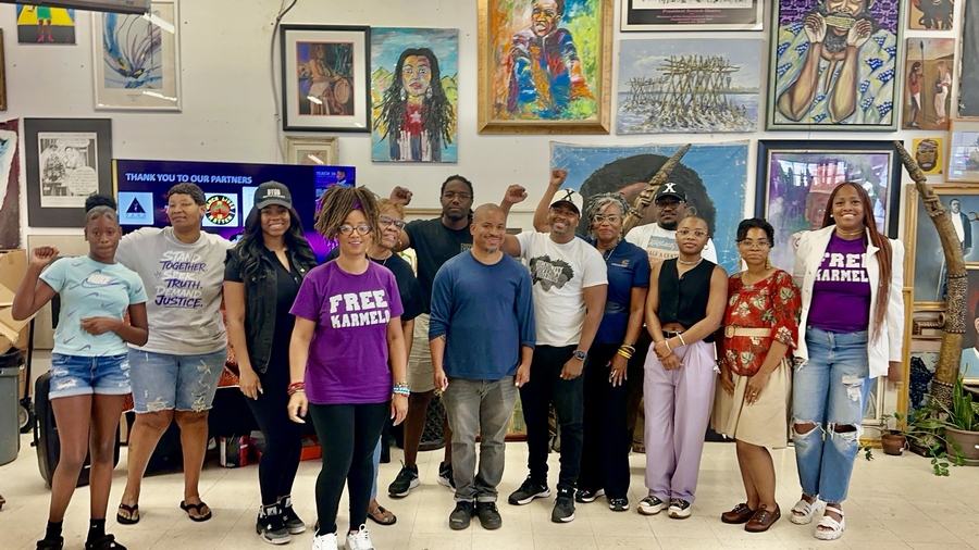 Organizers and partners standing together at the Free Karmelo teach-in